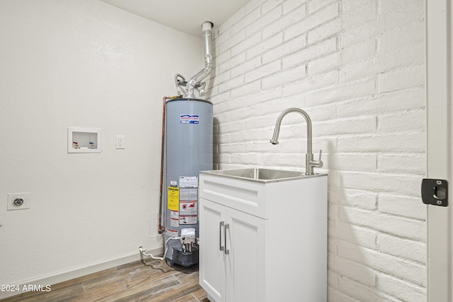 utilities with gas water heater and sink