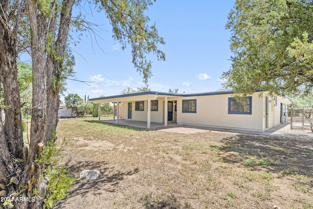 rear view of property featuring a patio