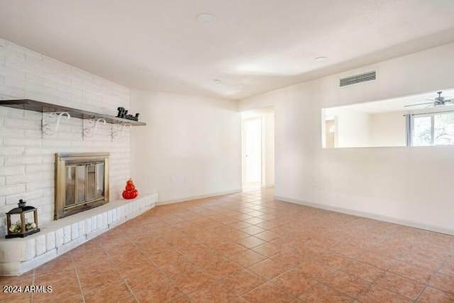 unfurnished living room with ceiling fan, light tile patterned floors, and a fireplace