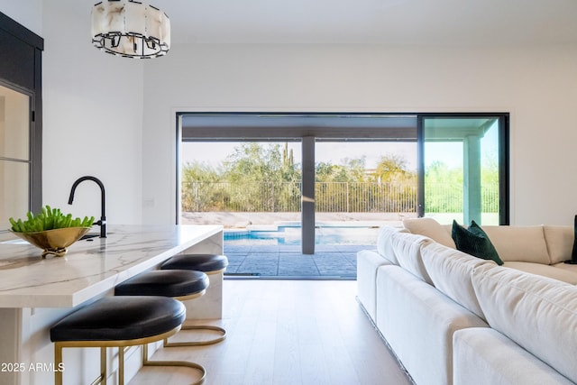 living area featuring a chandelier and wood finished floors