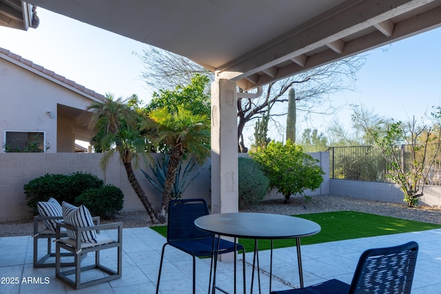 view of patio with outdoor dining area and a fenced backyard