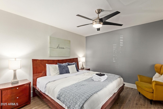 bedroom featuring wood finished floors, a ceiling fan, and baseboards