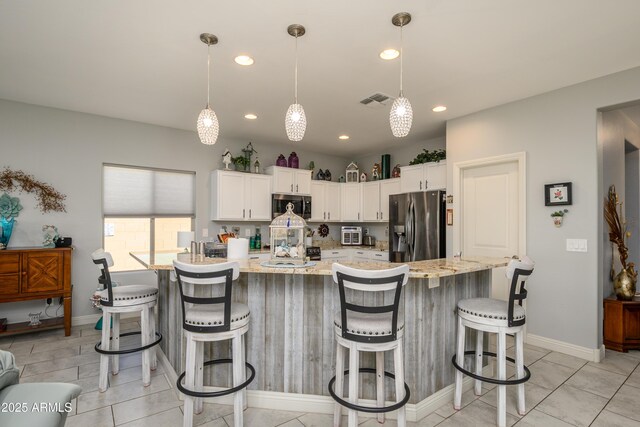 kitchen featuring visible vents, pendant lighting, recessed lighting, stainless steel appliances, and white cabinetry