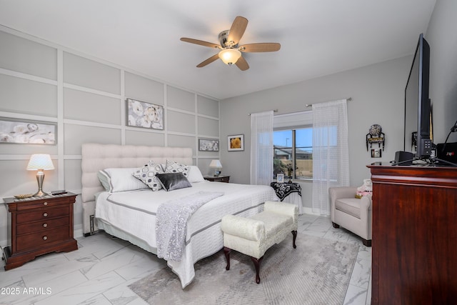 bedroom with marble finish floor and a ceiling fan