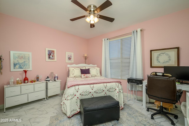 bedroom featuring a ceiling fan, marble finish floor, and baseboards