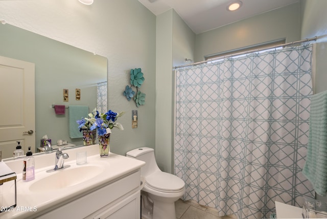 bathroom featuring curtained shower, toilet, vanity, and tile patterned flooring