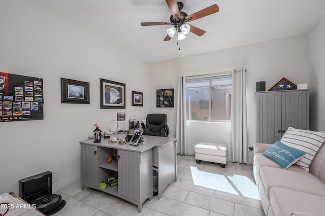 home office featuring baseboards, light tile patterned flooring, and a ceiling fan