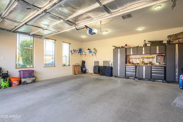 garage featuring visible vents and a garage door opener