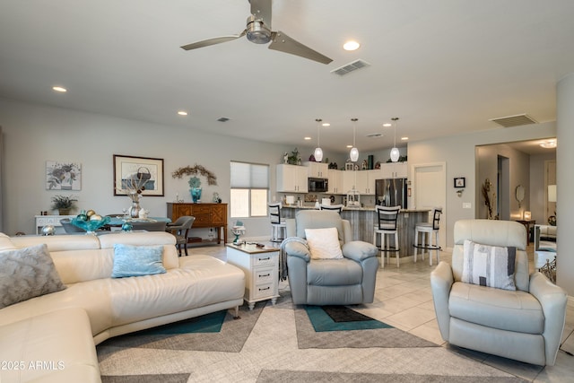 living room featuring light tile patterned floors, visible vents, recessed lighting, and a ceiling fan