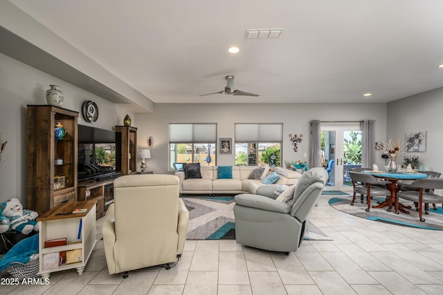 living area with light tile patterned floors, visible vents, recessed lighting, and ceiling fan