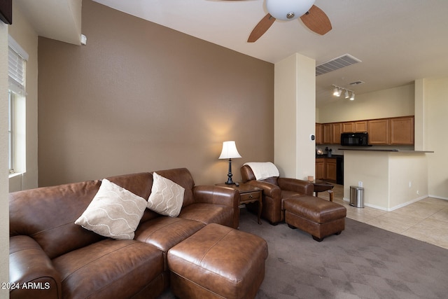 tiled living room featuring ceiling fan