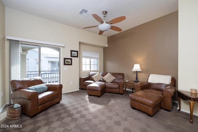 carpeted living room with ceiling fan