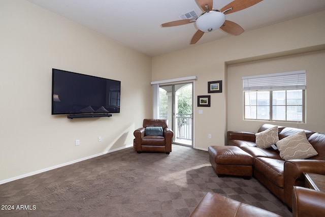 carpeted living room with ceiling fan