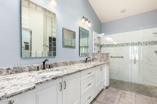 full bathroom featuring a stall shower, double vanity, and tile patterned flooring
