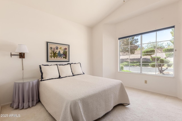 carpeted bedroom featuring lofted ceiling and baseboards
