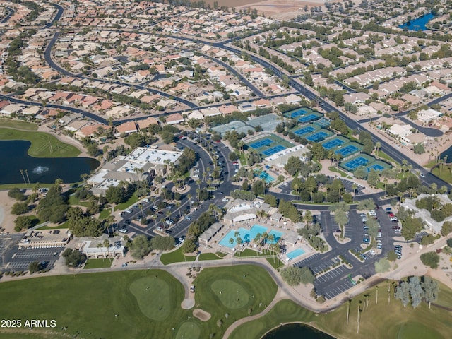aerial overview of property's location with a nearby body of water, a golf club, and nearby suburban area