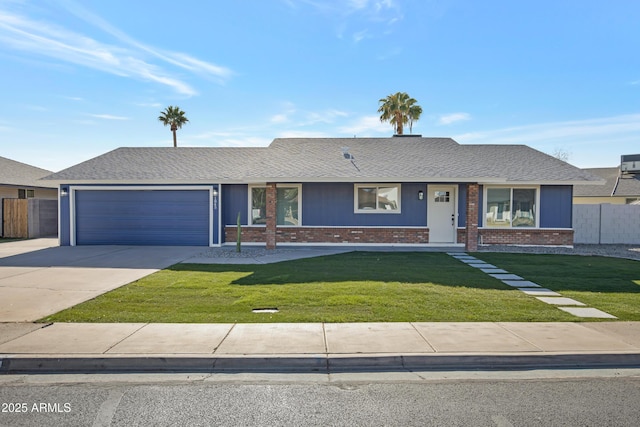 ranch-style home with a garage and a front yard