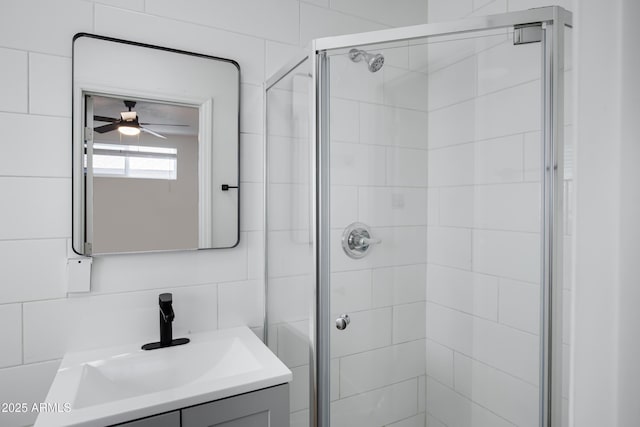 bathroom with vanity, an enclosed shower, and ceiling fan