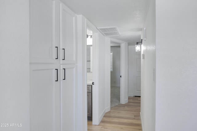 hall with light hardwood / wood-style flooring