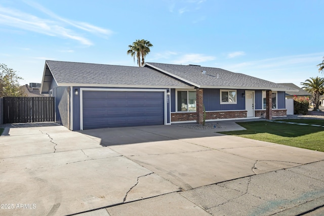 single story home featuring a garage and a front yard