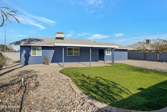 rear view of house with a patio, a yard, and central air condition unit