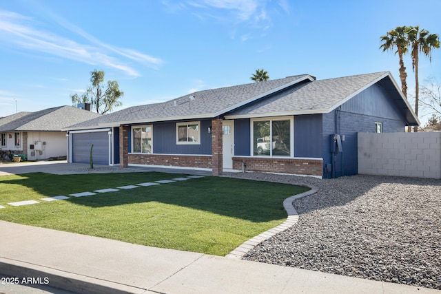 single story home featuring a garage and a front lawn