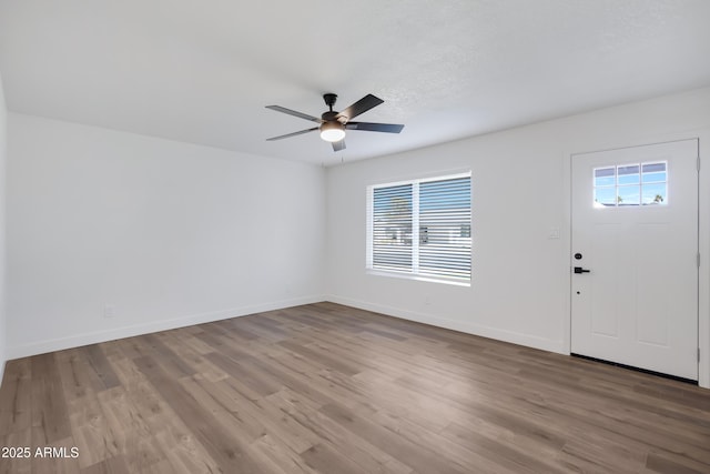 foyer entrance featuring ceiling fan, plenty of natural light, and light wood-type flooring