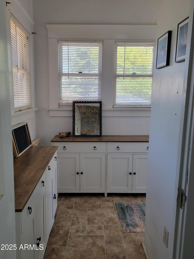 405 Powell St, Bisbee, AZ 85603 - kitchen with butcher block counters, plenty of natural light, and white cabinets