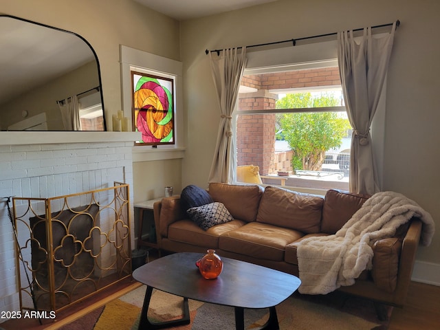405 Powell St, Bisbee, AZ 85603 - living room with wood finished floors and a brick fireplace