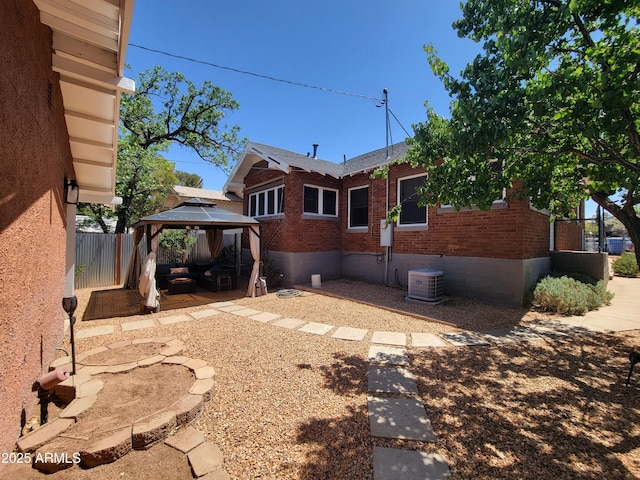 405 Powell St, Bisbee, AZ 85603 - back of house with brick siding, a gazebo, a patio area, and central AC unit