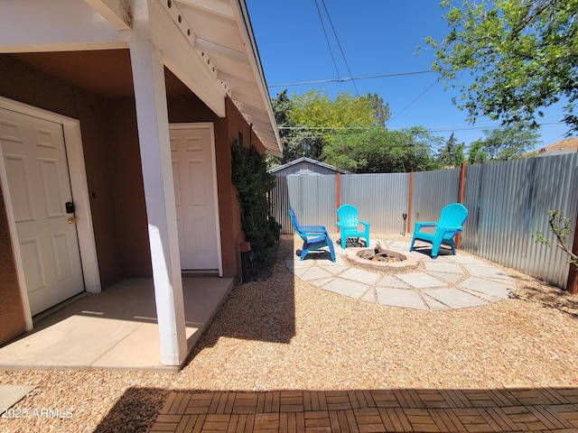405 Powell St, Bisbee, AZ 85603 - view of patio featuring an outdoor fire pit, a fenced backyard, a shed, and an outbuilding