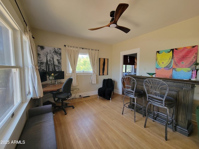 405 Powell St, Bisbee, AZ 85603 - home office featuring light wood finished floors, ceiling fan, a dry bar, and baseboards