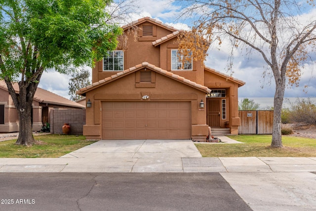 view of front of property with a tile roof, fence, driveway, and stucco siding