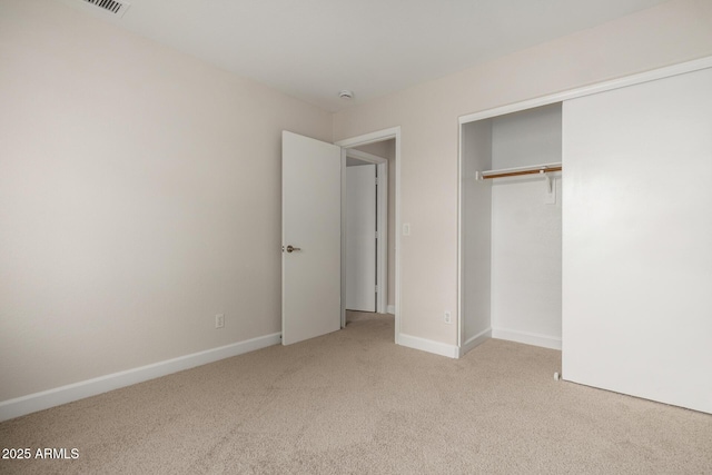 unfurnished bedroom featuring a closet, baseboards, and carpet