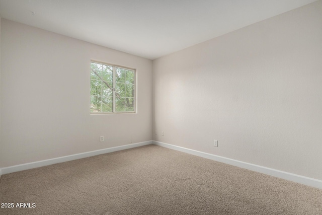 carpeted spare room with baseboards