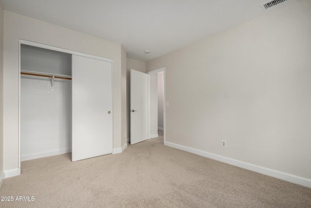 unfurnished bedroom featuring a closet, visible vents, carpet flooring, and baseboards