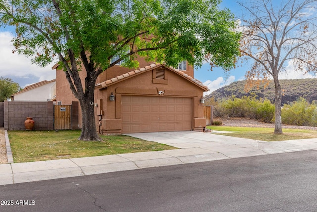 view of front of property with fence, concrete driveway, stucco siding, a garage, and a gate