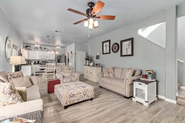 living room with ceiling fan and light hardwood / wood-style floors