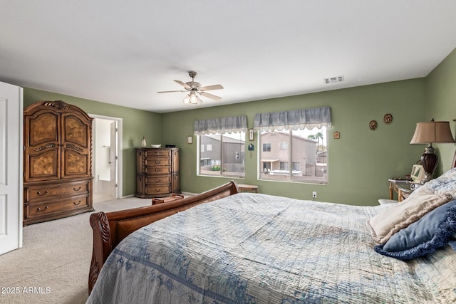 bedroom featuring carpet floors, ensuite bath, and ceiling fan