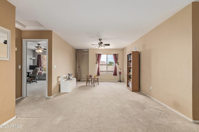 unfurnished living room with ceiling fan and light colored carpet