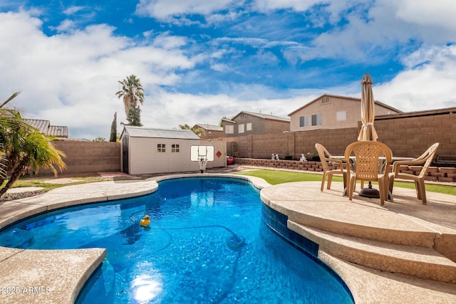 view of pool featuring a patio area and a storage shed