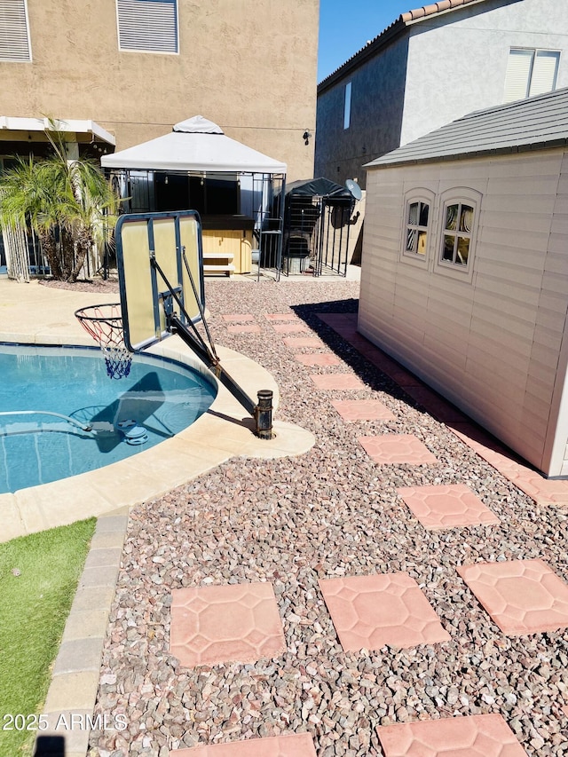 view of swimming pool featuring a gazebo and a patio