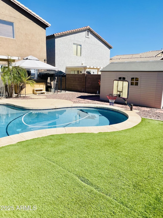 view of swimming pool featuring a gazebo, a patio area, an outdoor structure, and a lawn