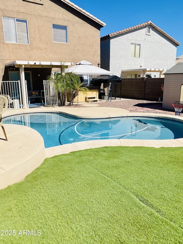 view of pool with a gazebo, a patio, and a lawn