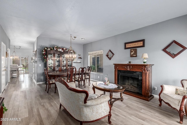 living room featuring light hardwood / wood-style flooring and a notable chandelier