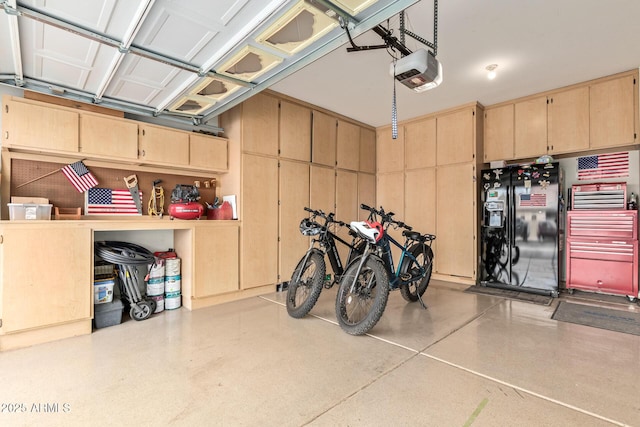 garage featuring black fridge and a garage door opener