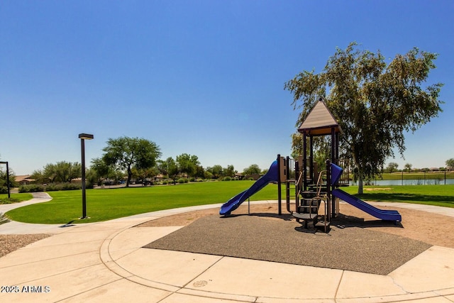 view of play area featuring a water view and a yard