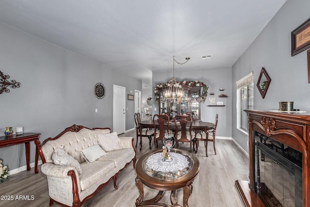 living room featuring an inviting chandelier and hardwood / wood-style flooring