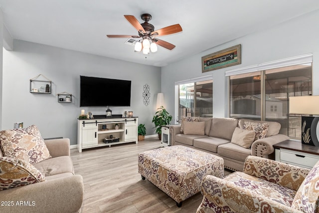 living room with ceiling fan and light wood-type flooring