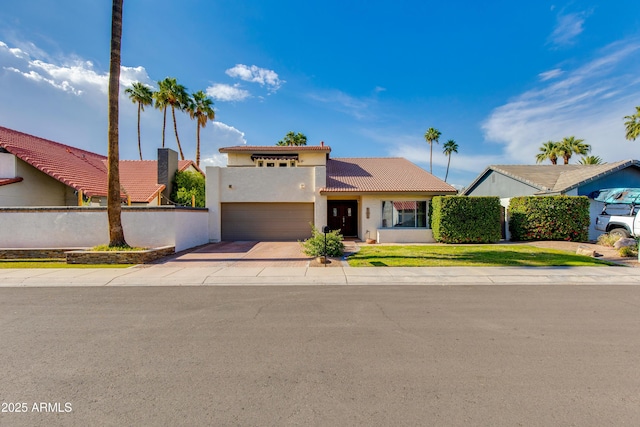1608 E Weathervane Ln, Tempe, AZ 85283 - mediterranean / spanish house featuring concrete driveway, a tiled roof, stucco siding, an attached garage, and fence